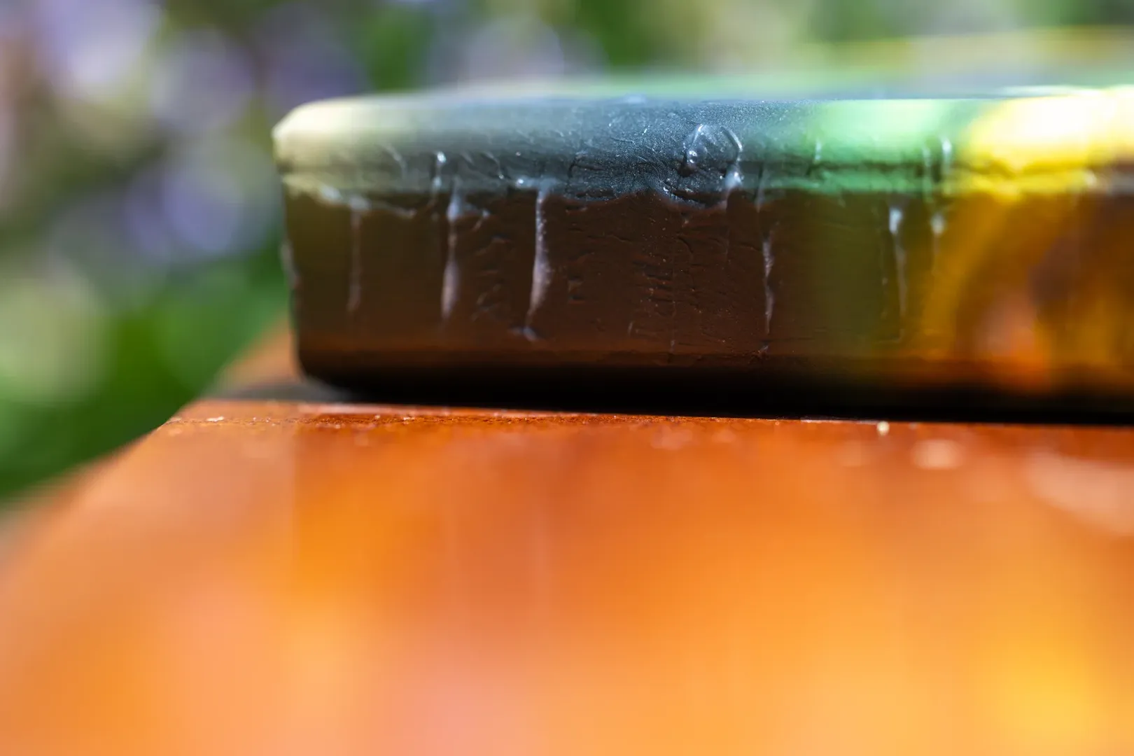 Close-up of a hand-painted keepsake box in Port Coquitlam, with textured nodules along the spine edge, designed as legacy art to hold photos and memories. Benefits of working with Olivia Greenland Photography is custom products like this. 